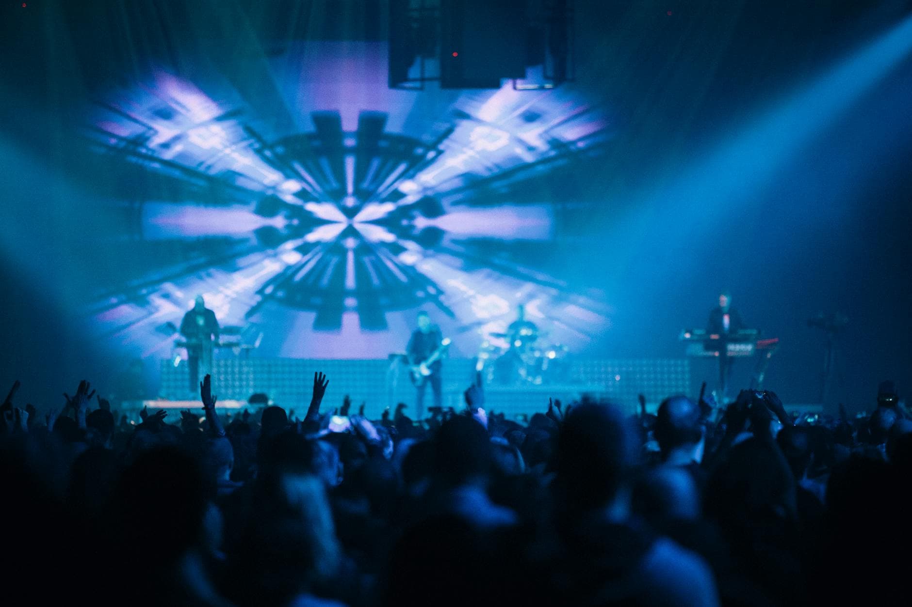 Blue crisscross beam pattern over audience
