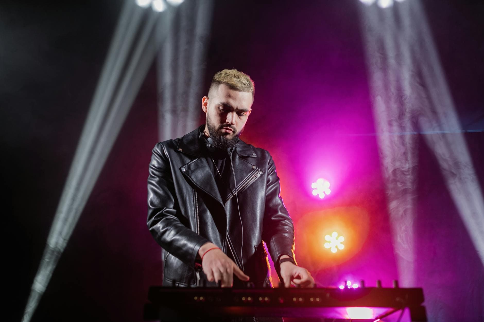 DJ performer with pink and purple backlighting